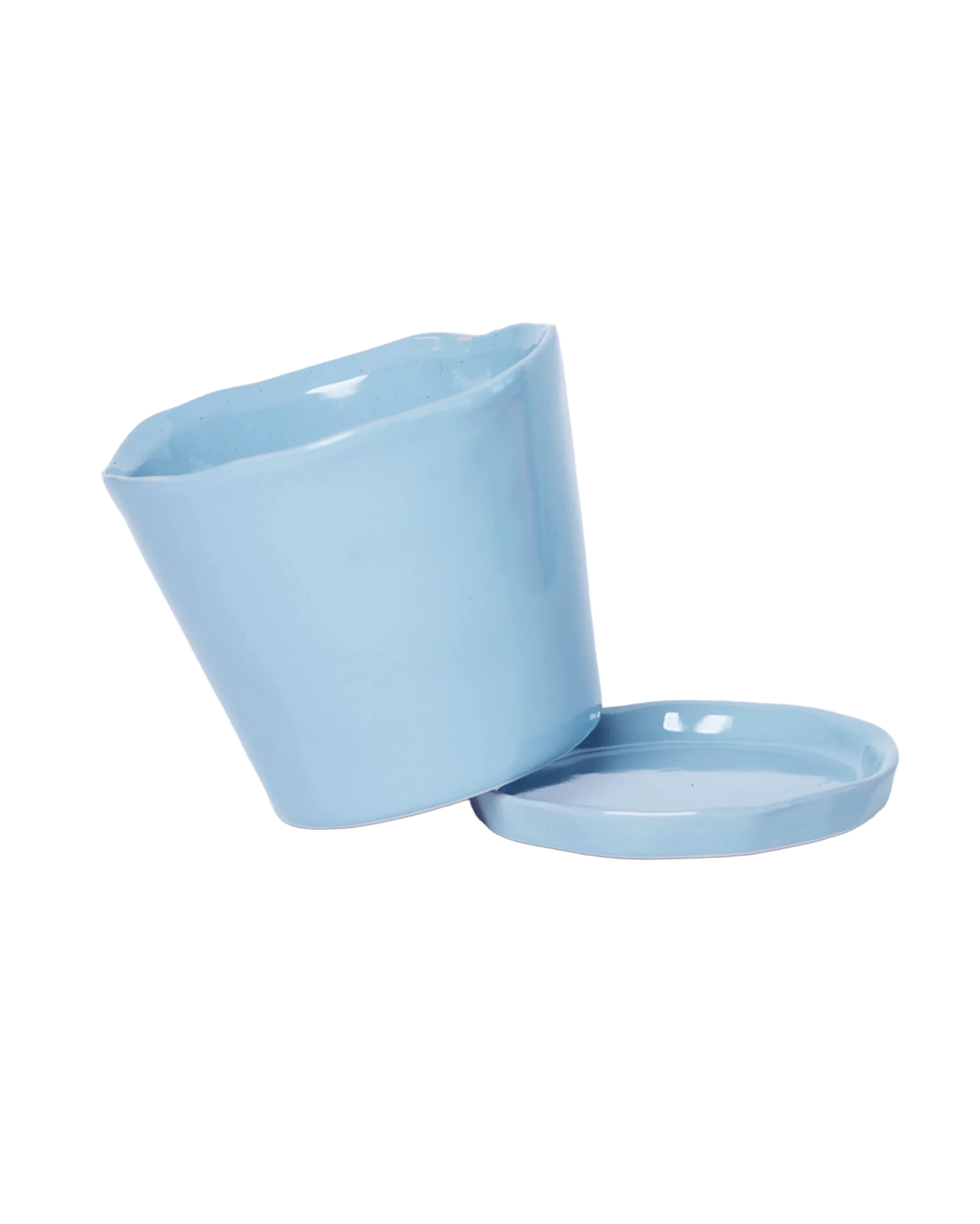 Close-up of the detachable saucer and drainage hole on a Chive Tika periwinkle ceramic medium pot.