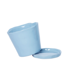 Close-up of the detachable saucer and drainage hole on a Chive Tika periwinkle ceramic medium pot.