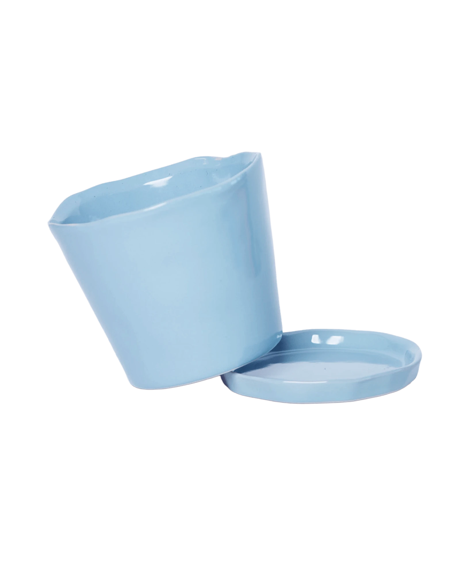 Close-up of the detachable saucer and drainage hole on a Chive Tika periwinkle ceramic medium pot.