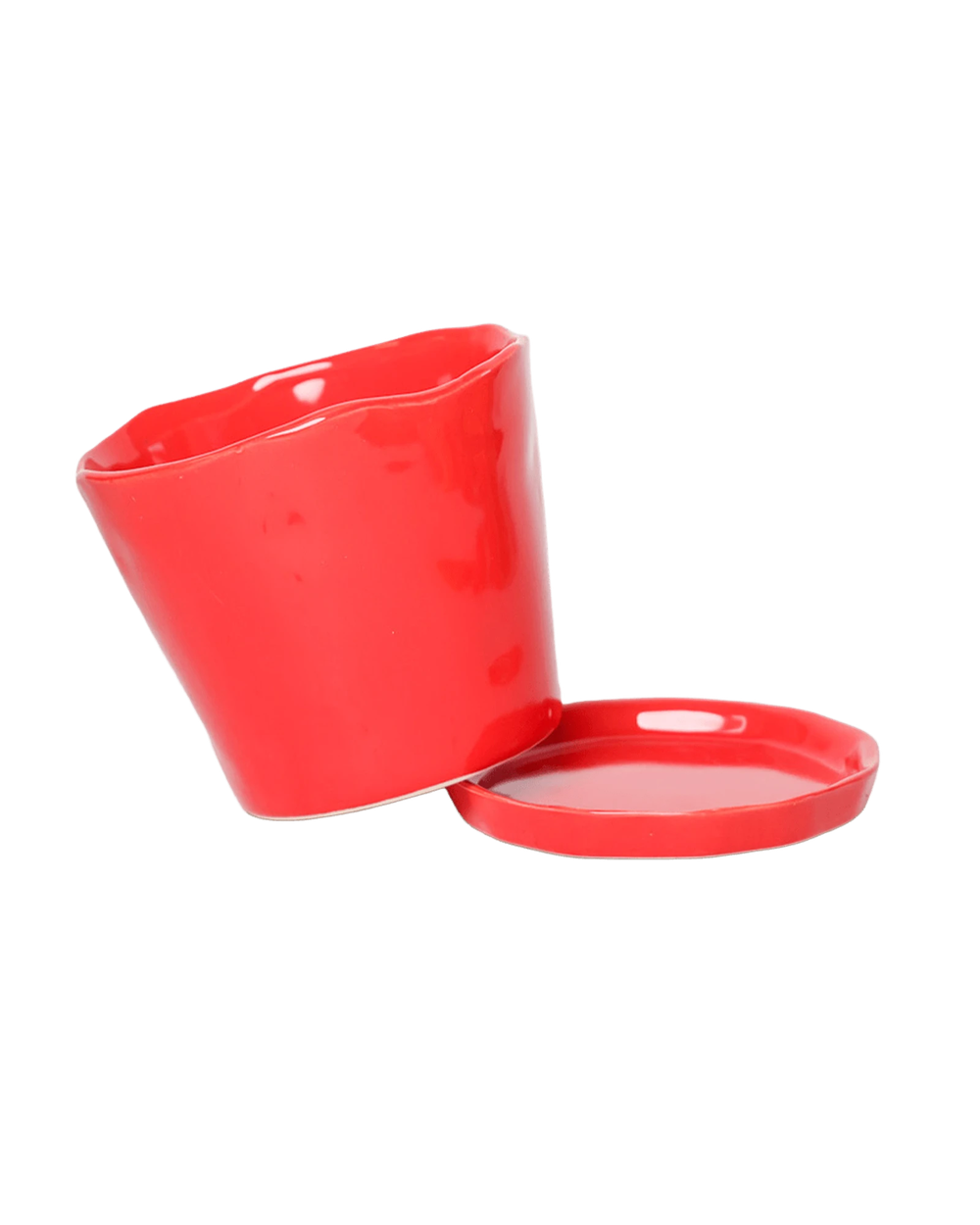 Close-up of the detachable saucer and drainage hole on a Chive Tika red ceramic medium pot.