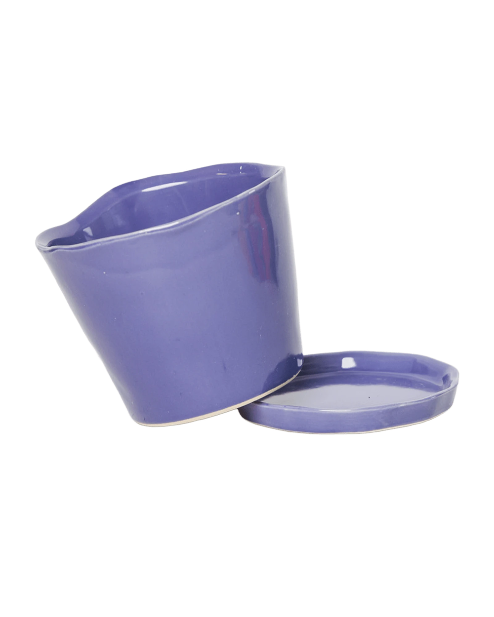 Close-up of the detachable saucer and drainage hole on a Chive Tika ultra violet ceramic medium pot.