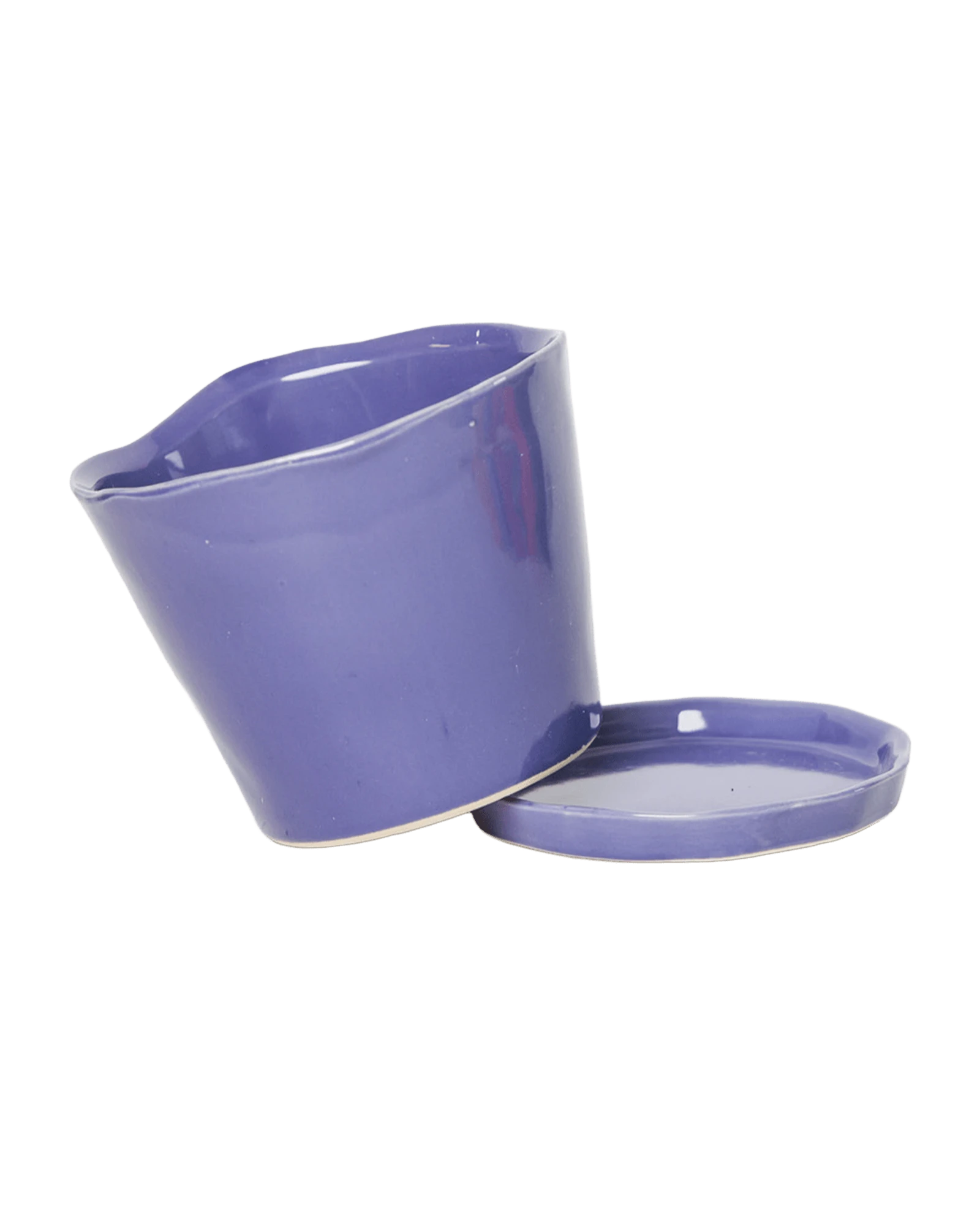 Close-up of the detachable saucer and drainage hole on a Chive Tika ultra violet ceramic medium pot.