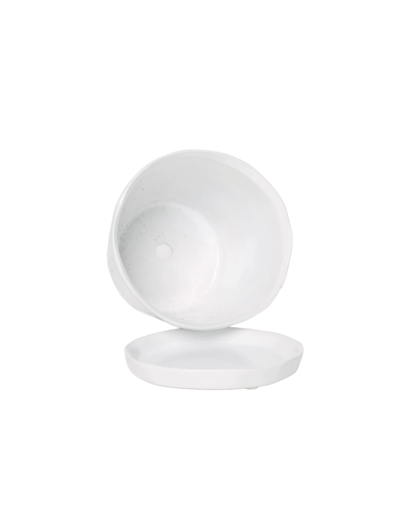 Close-up of the detachable saucer and drainage hole on a Chive Tika white ceramic large pot.