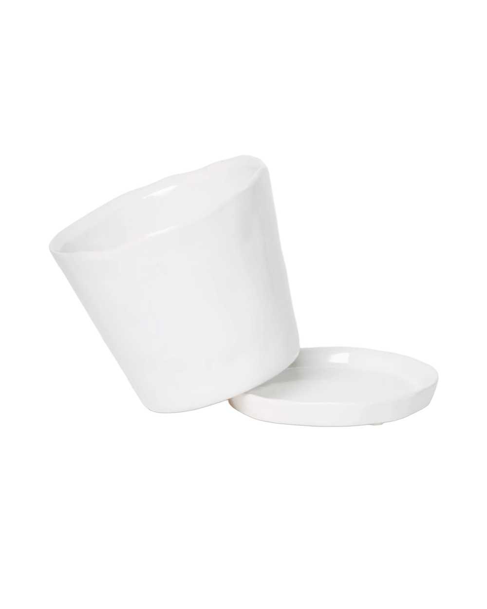 Close-up of the detachable saucer and drainage hole on a Chive Tika white ceramic medium pot.