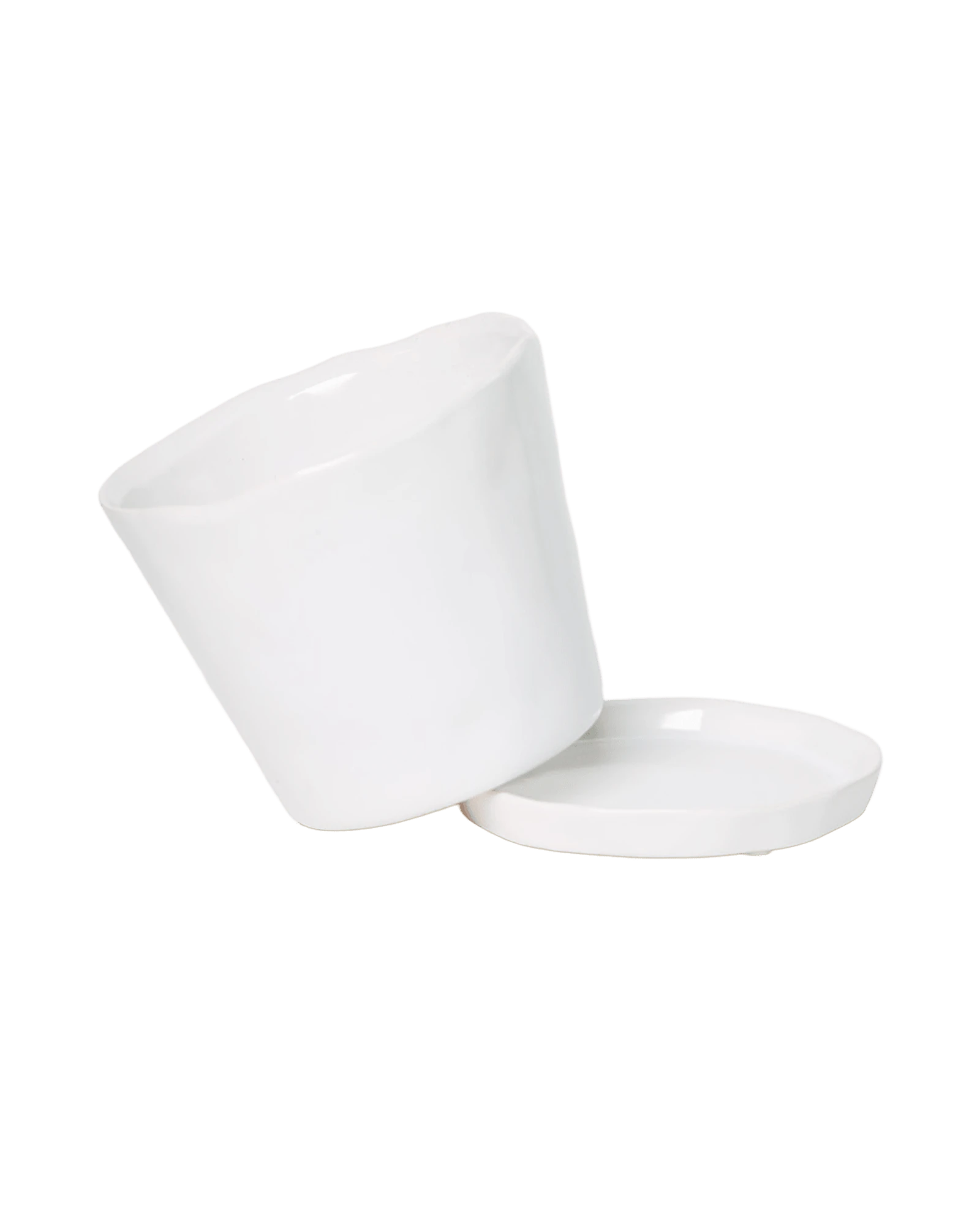 Close-up of the detachable saucer and drainage hole on a Chive Tika white ceramic medium pot.