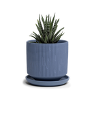 Chive Virago C medium blue grey porcelain pot with drainage and saucer styled with a plant.