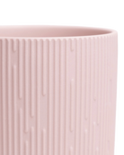Close-up of the Chive Virago C small soft pink porcelain pot showing the color and ribbed texture finish.