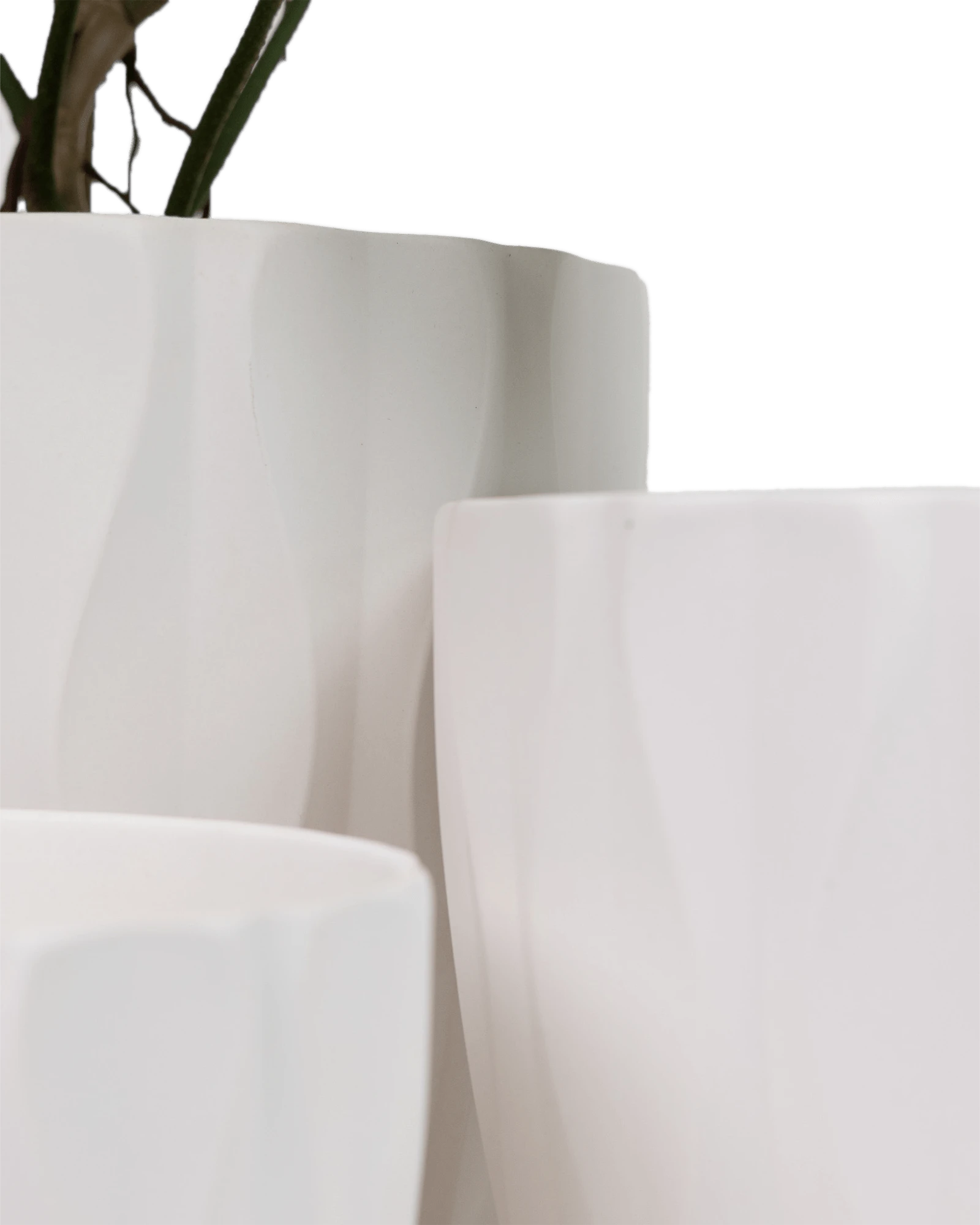 Close-up of three Chive Virago E white porcelain pots in large, medium, and small showing the vertical waves texture. 