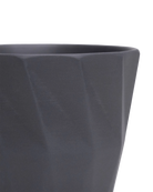 Close-up of the Chive Virago G medium black porcelain pot showing the color and geometric texture.