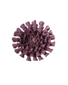A single sculptural flower-shaped product in a muted plum-purple color, photographed from above on a plain white background.