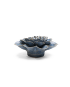 A small sculptural flower-shaped object with layered petals, shown on a clean white background. The item has a glossy dark blue glaze with lighter blue-gray highlights and a slightly distressed, rustic finish.