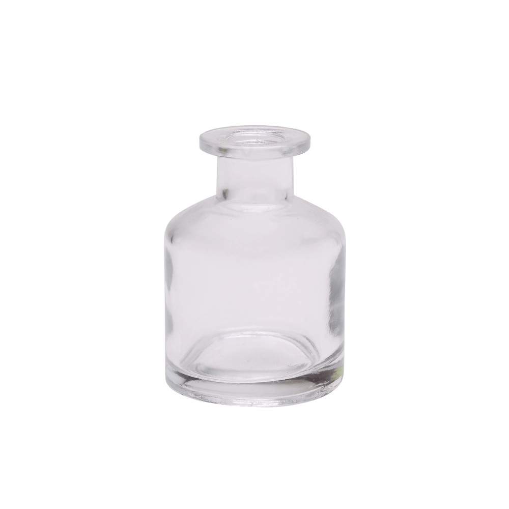Chive Loft apothecary glass bud vase in clear glass with a tall cylindrical silhouette and wide lip.