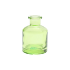 Chive Loft apothecary glass bud vase in green, shown straight-on with a smooth glossy finish.