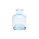 Chive Loft apothecary glass bud vase in light blue with a tall cylindrical silhouette and wide lip.