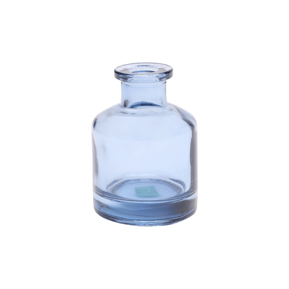 Chive Loft apothecary glass bud vase in medium blue with a tall cylindrical silhouette and wide lip.