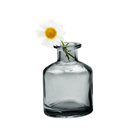 Chive Loft apothecary glass bud vase in smoke grey styled with a single white daisy bloom.