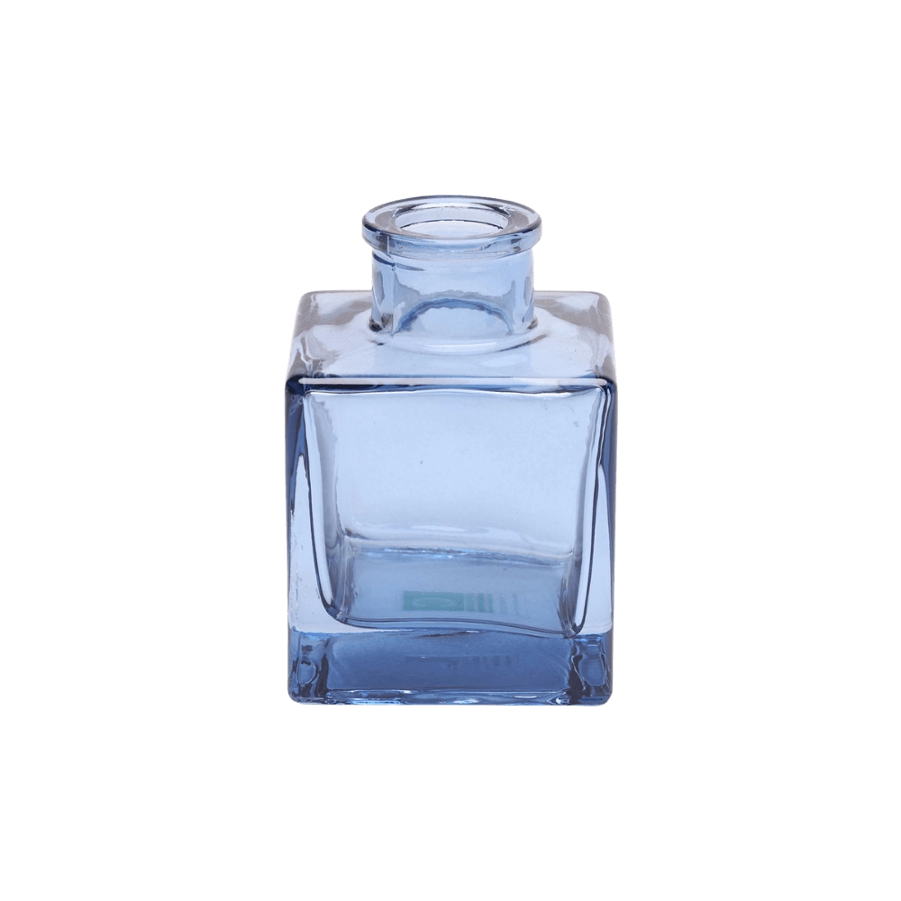 Chive Loft cube glass bud vase in medium blue with a raised collar neck and clean square silhouette.