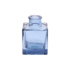 Chive Loft cube glass bud vase in medium blue with a raised collar neck and clean square silhouette.