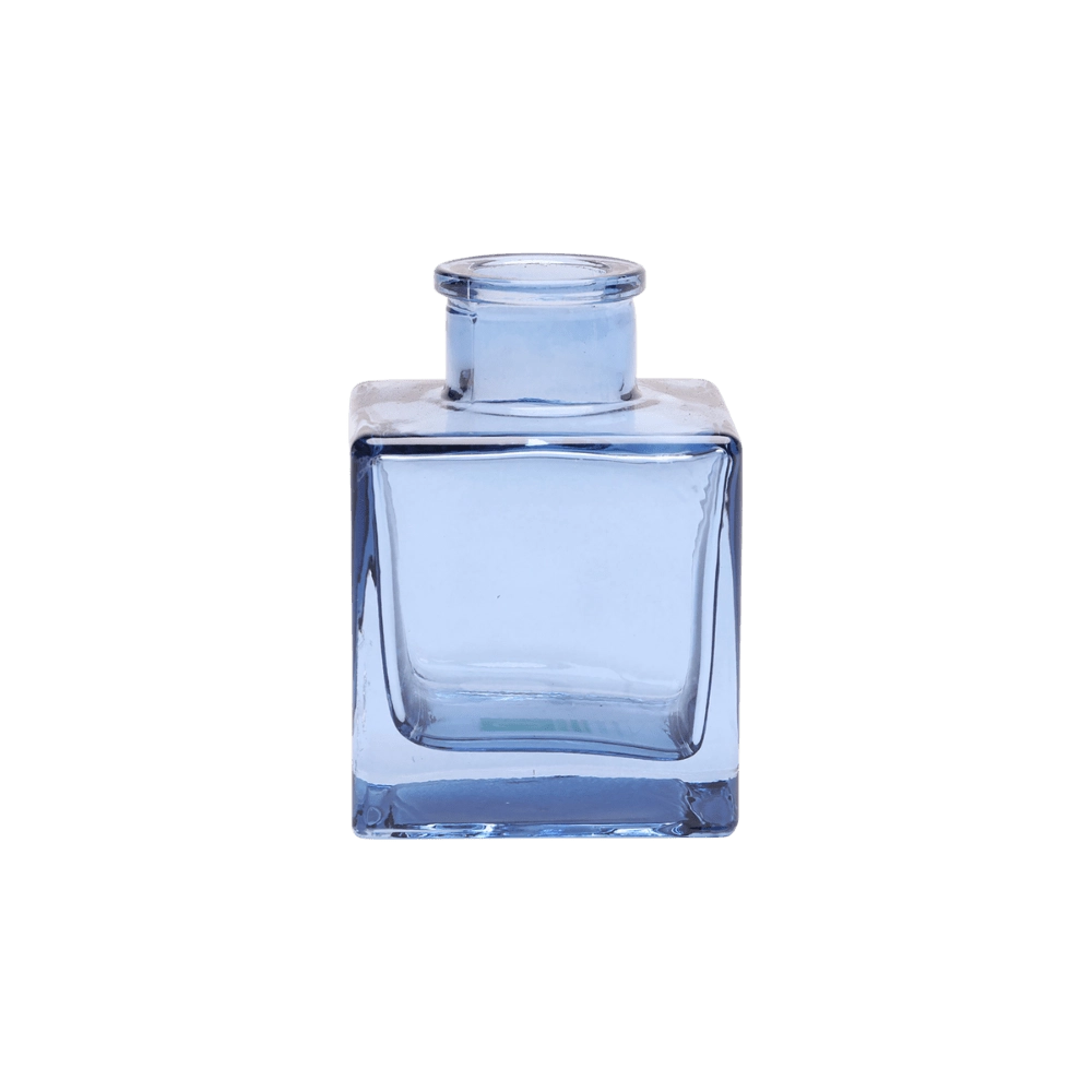 Chive Loft cube glass bud vase in medium blue, shown at an angle with a glossy faceted finish.