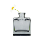 Chive Loft cube glass bud vase in smoke grey styled with a single white daisy bloom.