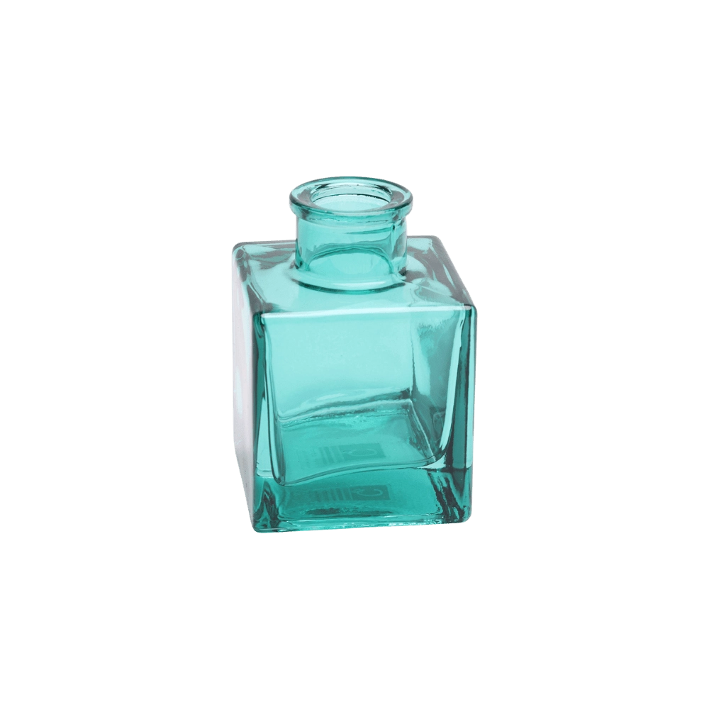 Chive Loft cube glass bud vase in teal, shown at an angle with a glossy faceted finish.