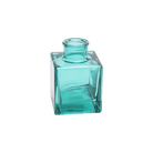 Chive Loft cube glass bud vase in teal, shown at an angle with a glossy faceted finish.
