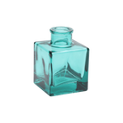 Chive Loft cube glass bud vase in teal, straight-on view highlighting the sharp square edges.