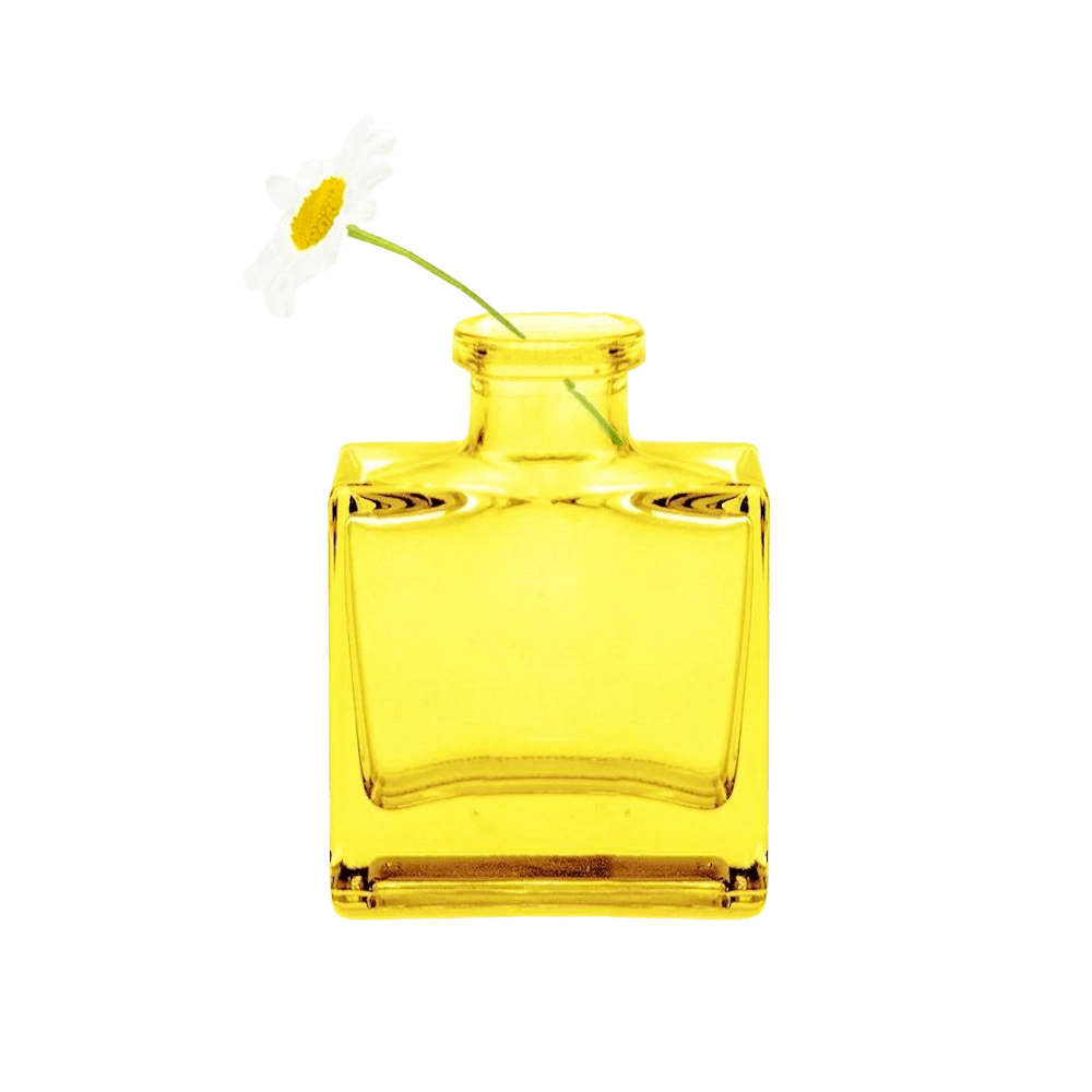 Chive Loft cube glass bud vase in yellow styled with a single white daisy bloom.