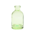 Chive Loft tall glass bud vase in green with a slender neck and rounded shoulder.