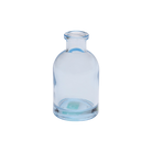 Chive Loft tall glass bud vase in light blue with a slender neck and rounded shoulder.