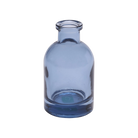 Chive Loft tall glass bud vase in medium blue with a slender neck and rounded shoulder.