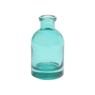 Chive Loft tall glass bud vase in teal with a slender neck and rounded shoulder.