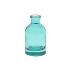 Chive Loft tall glass bud vase in teal, shown straight-on with a smooth glossy finish.