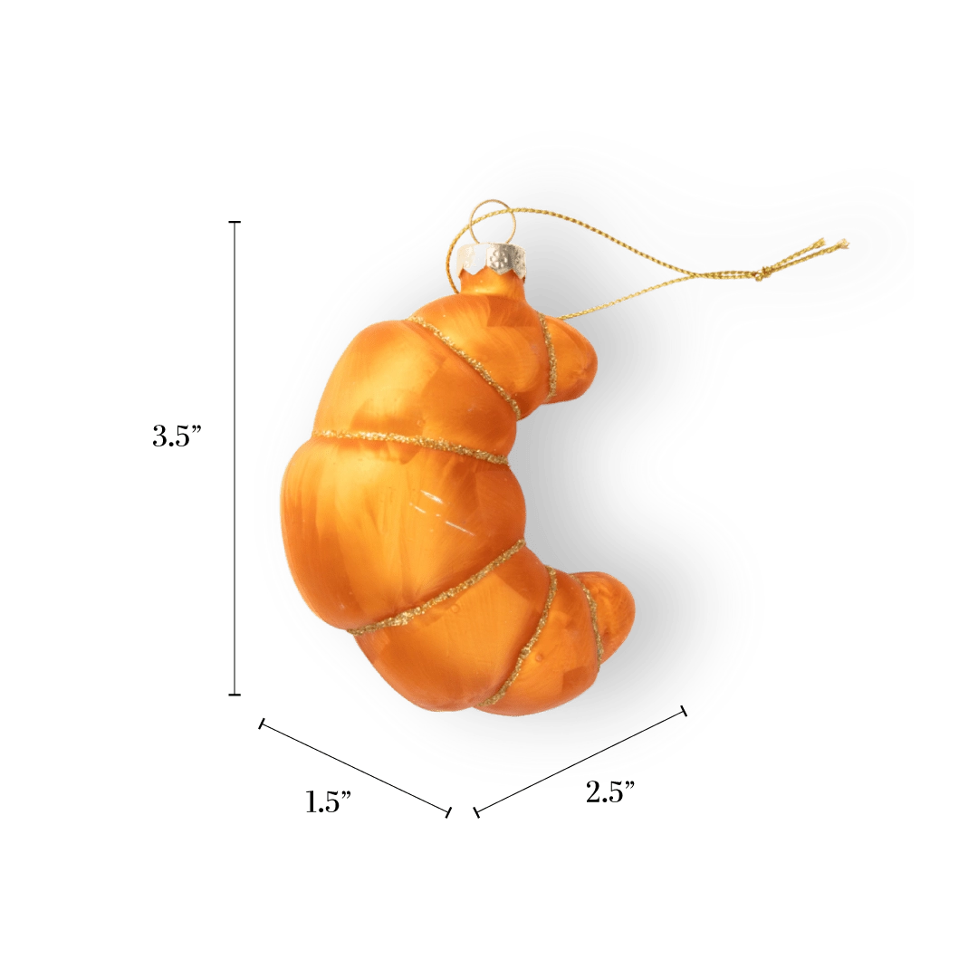 Chive glass croissant ornament in golden orange with a gold glitter spiral wrap.