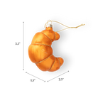 Chive glass croissant ornament in golden orange with a gold glitter spiral wrap.