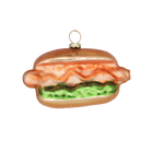 Chive glass hot dog ornament with ketchup and relish detail on a soft bun.
