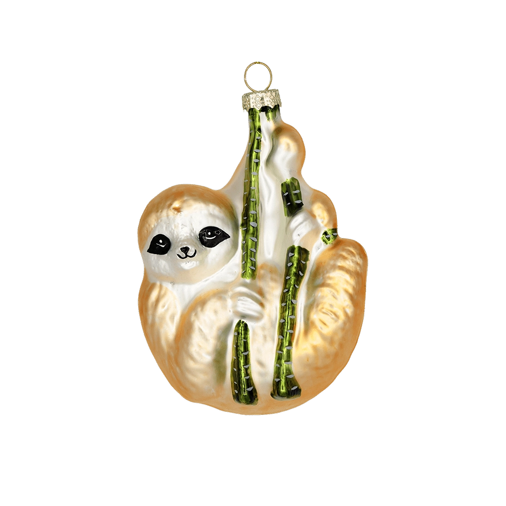 Chive glass sloth ornament in tan and cream, clinging to green branches.