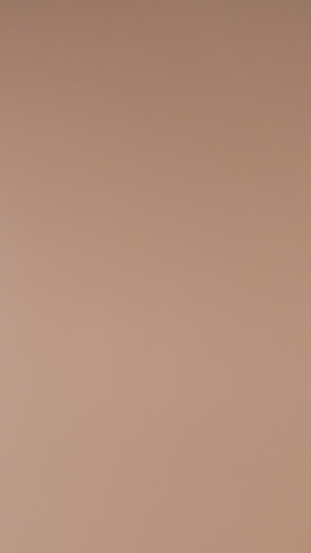 Burnt yellow elegance ranunculus ceramic wall flower tossed elegantly against a neutral background in slow motion — France Collection — Chive Studio