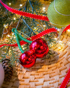 Cherries ornament styled on a decorated Christmas tree