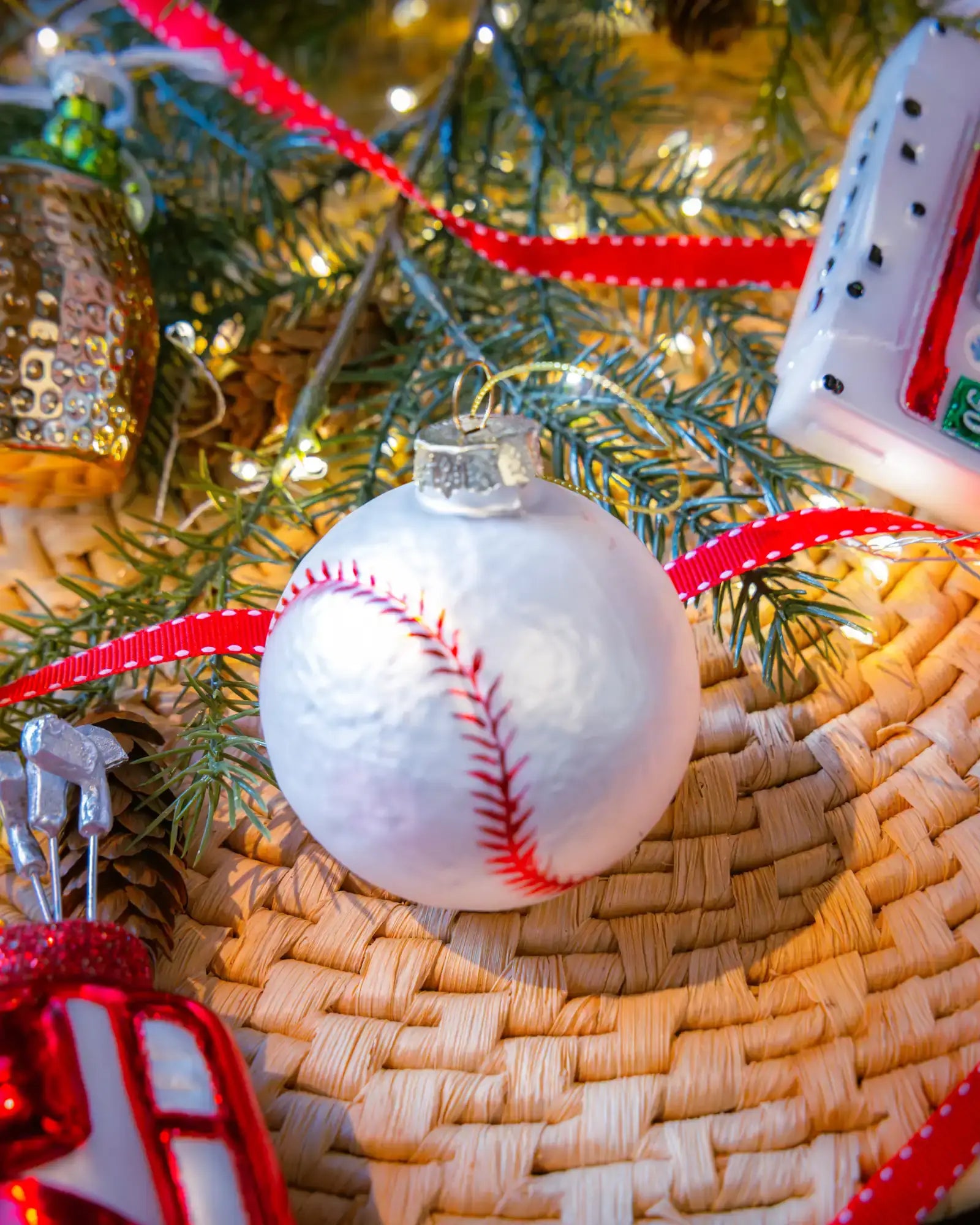 Baseball ornament styled on a decorated Christmas tree